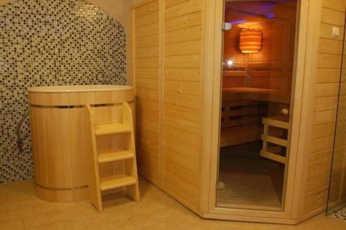 a room with a wooden closet with a glass door at Apartmán Hory in Štrbské Pleso