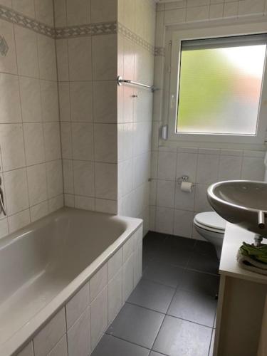 a bathroom with a tub and a toilet and a sink at WORK & Rest Monteurzimmer in Batzhausen