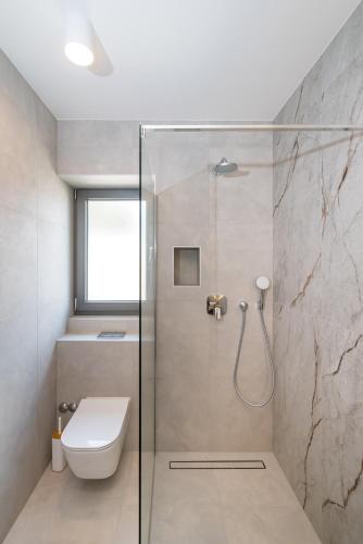 a bathroom with a shower with a toilet and a sink at Villa Cvita west in Primošten
