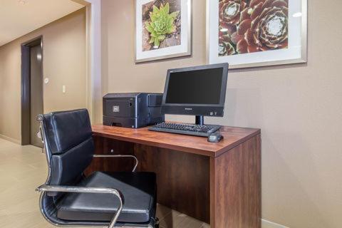 a desk with a computer on top of it at Suburban Studios Midland I-20 in Midland
