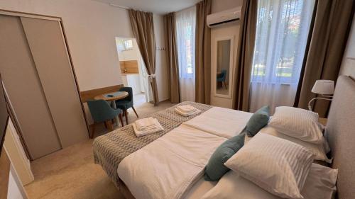 a bedroom with a large bed and a table at Apartments Cassia in Mali Lošinj