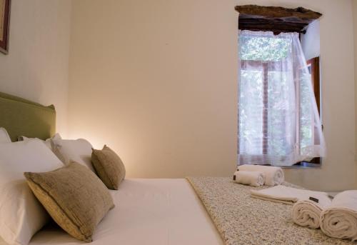 a bedroom with a white bed with a window at Feneri- cozy Apartment 20' from Elafonisi beach in Elafonisi