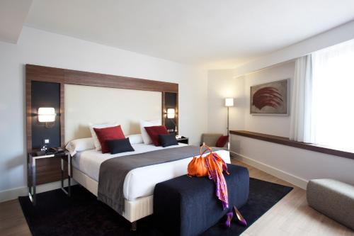 Habitación de hotel con cama grande y sofá en Hotel Princesa Plaza Madrid en Madrid
