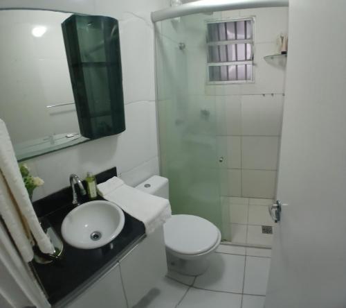 a bathroom with a sink and a toilet and a shower at Cantinho da Deusa in São José de Ribamar