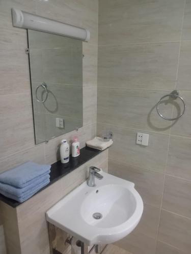 a bathroom with a sink and a mirror at Margalla Hills View Apartment Islamabad in Islamabad
