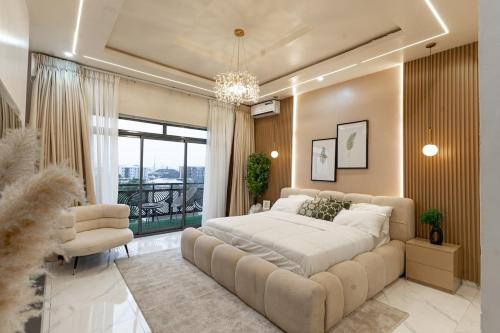 a bedroom with a large bed and a large window at Mirage in Lekki