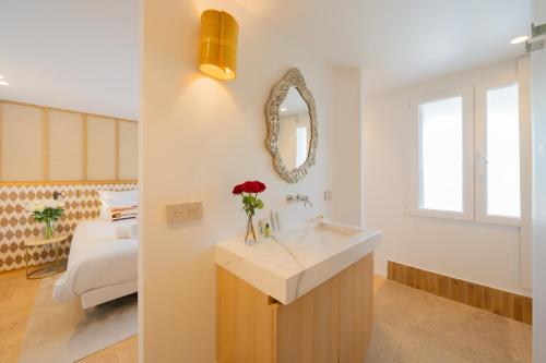 a bathroom with a sink and a room with a bed at Lou Saint-Tropez in Saint-Tropez