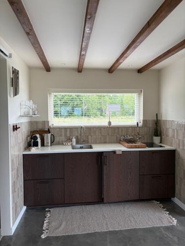 a large kitchen with a sink and a window at Studio34 in Hauwert