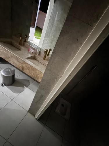 a bathroom with a sink and a window at شاليه ماديرا in Hail