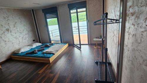 a bedroom with a bed in a room with a shower at Splav Rio in Aluga
