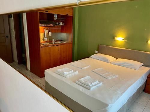 a bedroom with a bed with two towels on it at Hotel Evagelia in Leptokarya