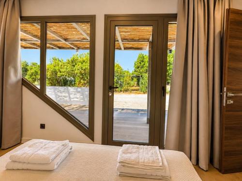 a bedroom with a bed with two white towels on it at Simos Camping Elafonisos Tents & Bungalows in Elafonisos
