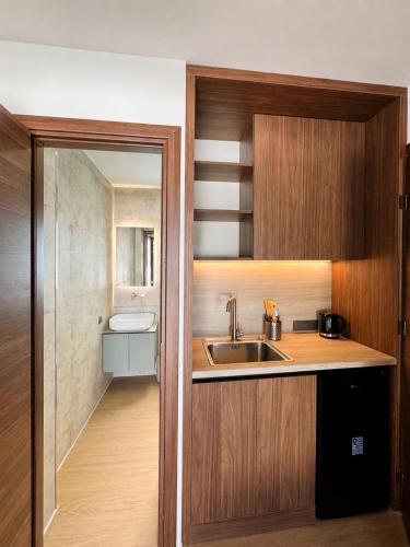 a small kitchen with a sink and a mirror at Simos Camping Elafonisos Tents & Bungalows in Elafonisos