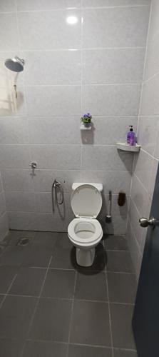 a bathroom with a white toilet and a shower at Homestay Cikgu 2 Hospital Kuala Krai in Kuala Kerai