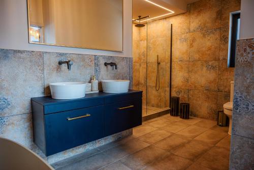 a bathroom with two sinks and a shower at Retreat 1 in Beccles