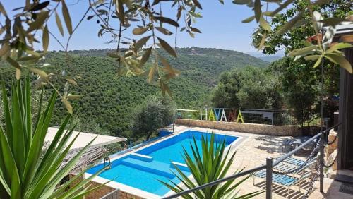 a swimming pool with a view of a mountain at Havana chalet in Jrabtā