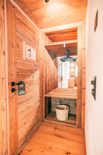 a room with a sauna in a wooden cabin at Nînda Boutique Hôtel in Nendaz
