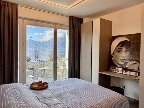 a bedroom with a bed and a large window at Lakeview in Luino