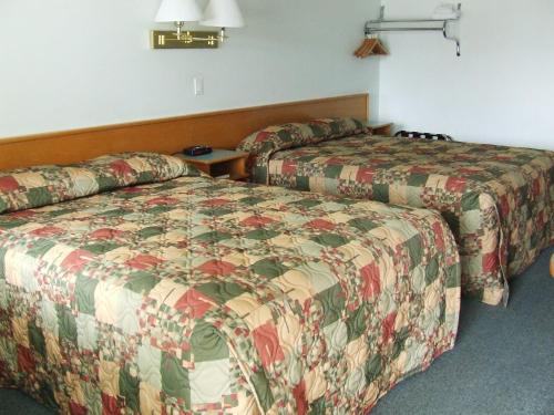 a hotel room with two beds in a room at Ponderosa Motor Inn in Golden
