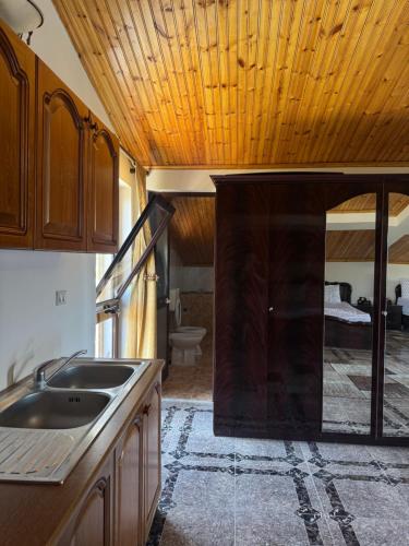 a kitchen with a sink and a bathroom with a bed at Villa Velipoj in Velipojë
