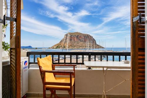 a balcony with a table and a view of a mountain at Matroni's House - Seafront Getaway in Monemvasia in Monemvasia