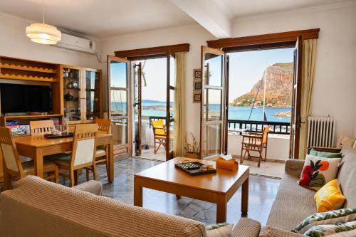 a living room with a view of the ocean at Matroni's House - Seafront Getaway in Monemvasia in Monemvasia