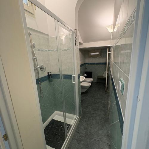 a bathroom with a glass shower and a toilet at Affittacamere Nel Cuore di Faenza in Faenza