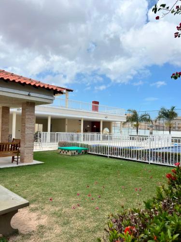 a house with a white fence and a yard at AP da Vicky 2 quartos central São Luis in São Luís