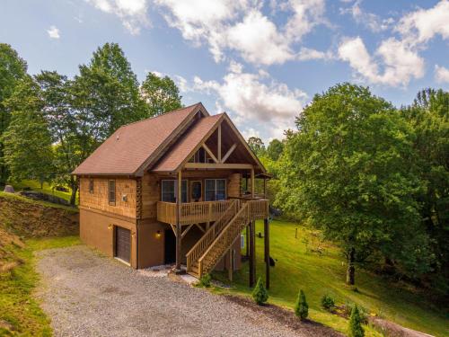 a tree house with a staircase leading up to it at Beaver Rock Lodge in Elk Park