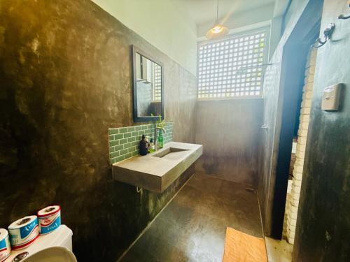 a bathroom with a sink and a mirror at REZ SPACE Apartment 05 in Hiriketiya