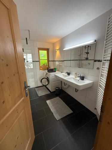 a bathroom with two sinks and a mirror at Apartment Andal in Lenggries