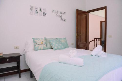 a bedroom with two beds with towels on them at Casa Meiramar in Moaña