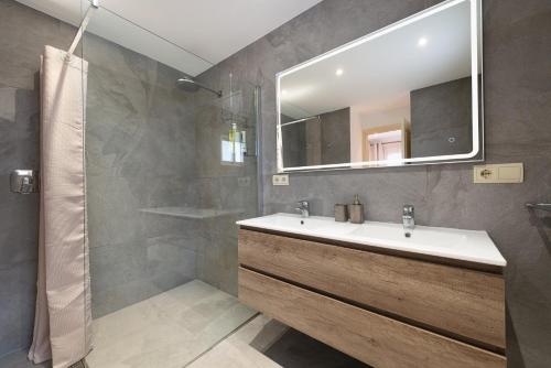 a bathroom with a sink and a mirror at Villa Hilary in Playa de Muro