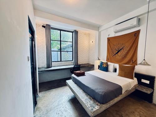 a bedroom with a large bed with a head board at REZ SPACE Apartment 06 in Hiriketiya