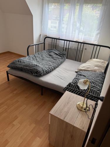 a bedroom with two beds and a wooden table at Apartment in Reigoldswil in Reigoldswil
