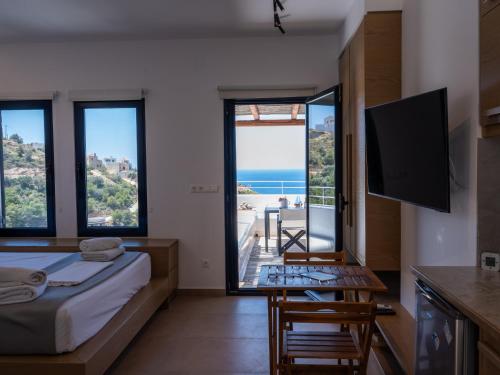 a bedroom with a bed and a view of the ocean at Blue Dawn Kalymnos in Kalymnos
