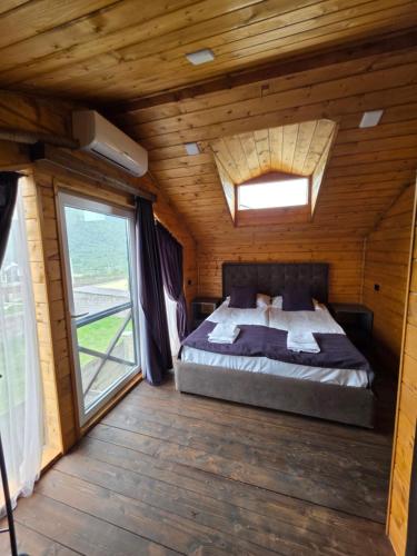 a bedroom with a bed in a wooden cabin at Swiss House Dilijan in Dilijan