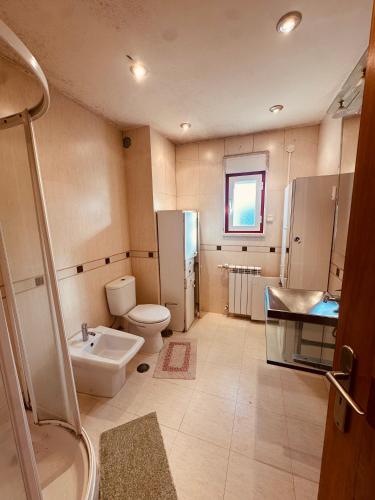 a bathroom with a sink and a toilet and a shower at Rua Gama Barros 22 SUITE in Charneca