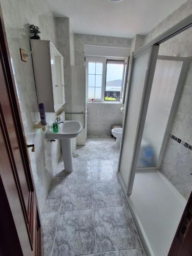 a bathroom with a shower and a sink and a toilet at Las 4 columnas (MFA) in Muxia
