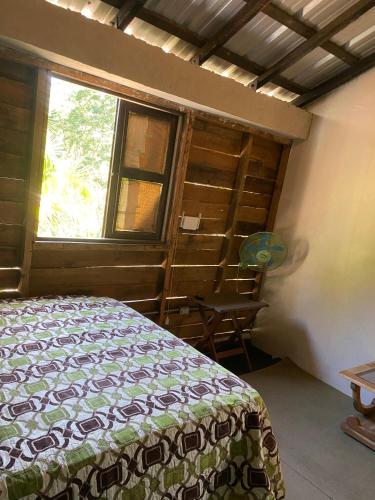 a bedroom with a bed and a window at Villa Esperanza in San Cristóbal