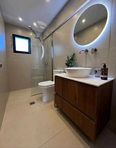 a bathroom with a sink and a toilet and a mirror at Alonnisos - Sea View Studio Appartment in Alonnisos
