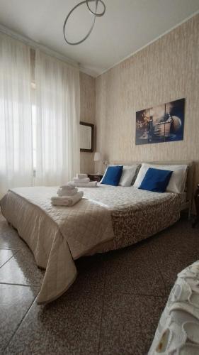 a large bed with blue pillows in a bedroom at La Casa di Giosy in Cairo Montenotte