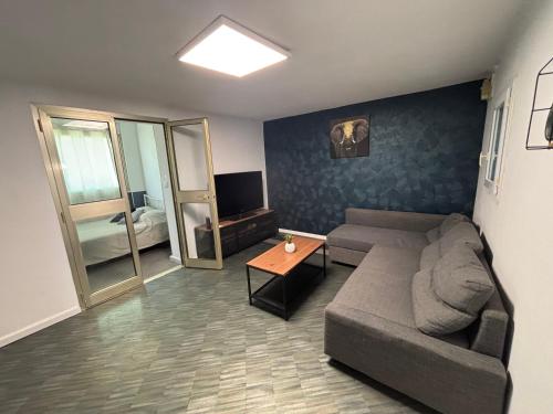 a living room with a couch and a table at My Pradet in Le Pradet