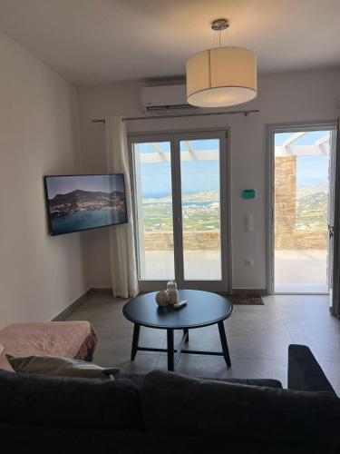 a living room with a couch and a table at Villa House Theasis in Kampos Paros