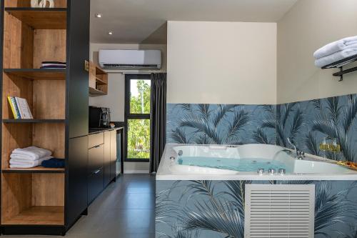 a bathroom with a bath tub in a room at yoga Lake view in Had Nes