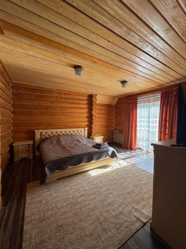 a bedroom with a bed in a wooden room at PRINCE Villa in Shaian