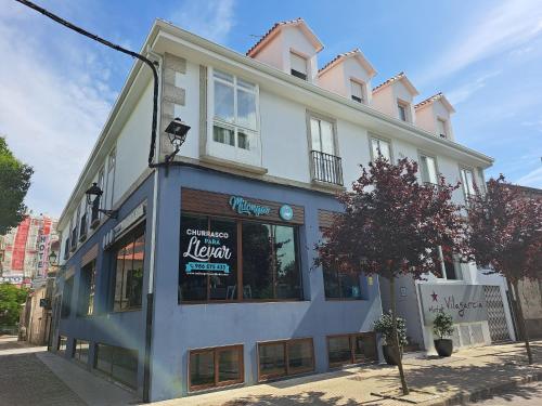 a large white building with a sign on it at Hotel Vilagarcia in Vilagarcia de Arousa