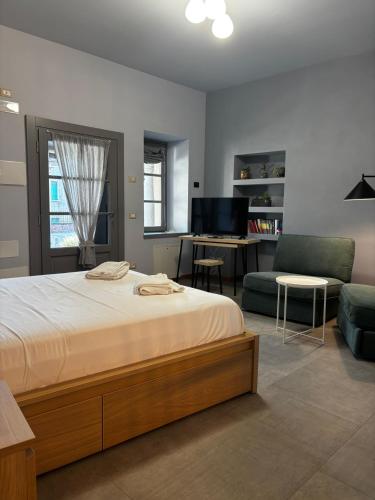a bedroom with a bed and a couch and a desk at Dimora Federica in Erbusco