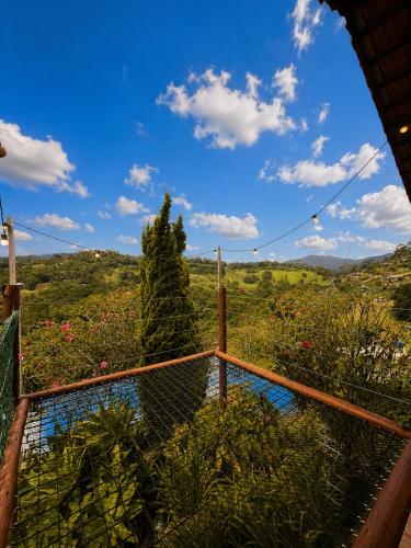 a view from the balcony of a house with a fence at Refugio nas Alturas LANDIN & CHARM in Santo Antônio do Pinhal