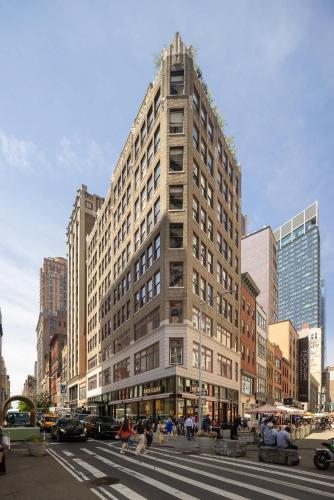 a tall building on a city street with a crosswalk at Broadway Hotel in the Flatiron District in New York